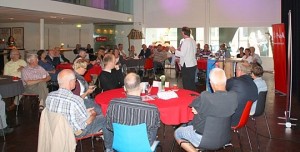 Volle zaal met in witte shirt Hans Spekman